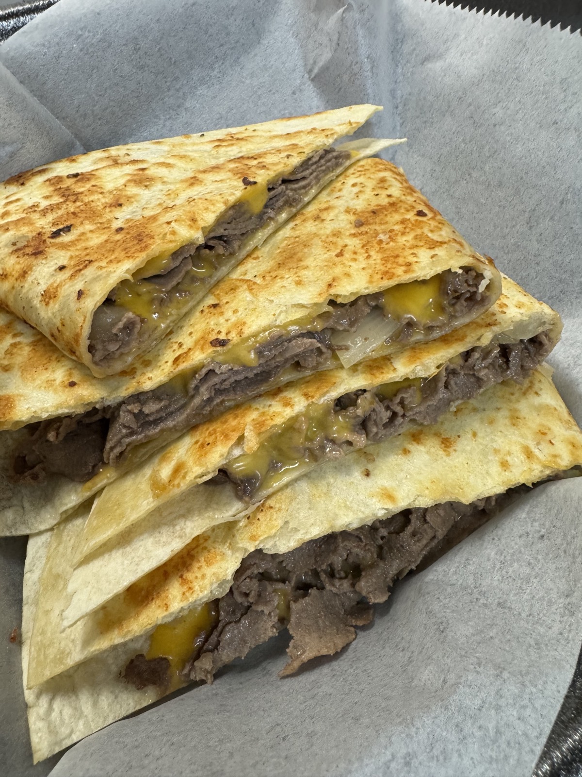 Steak quesadilla wedges with melted cheese