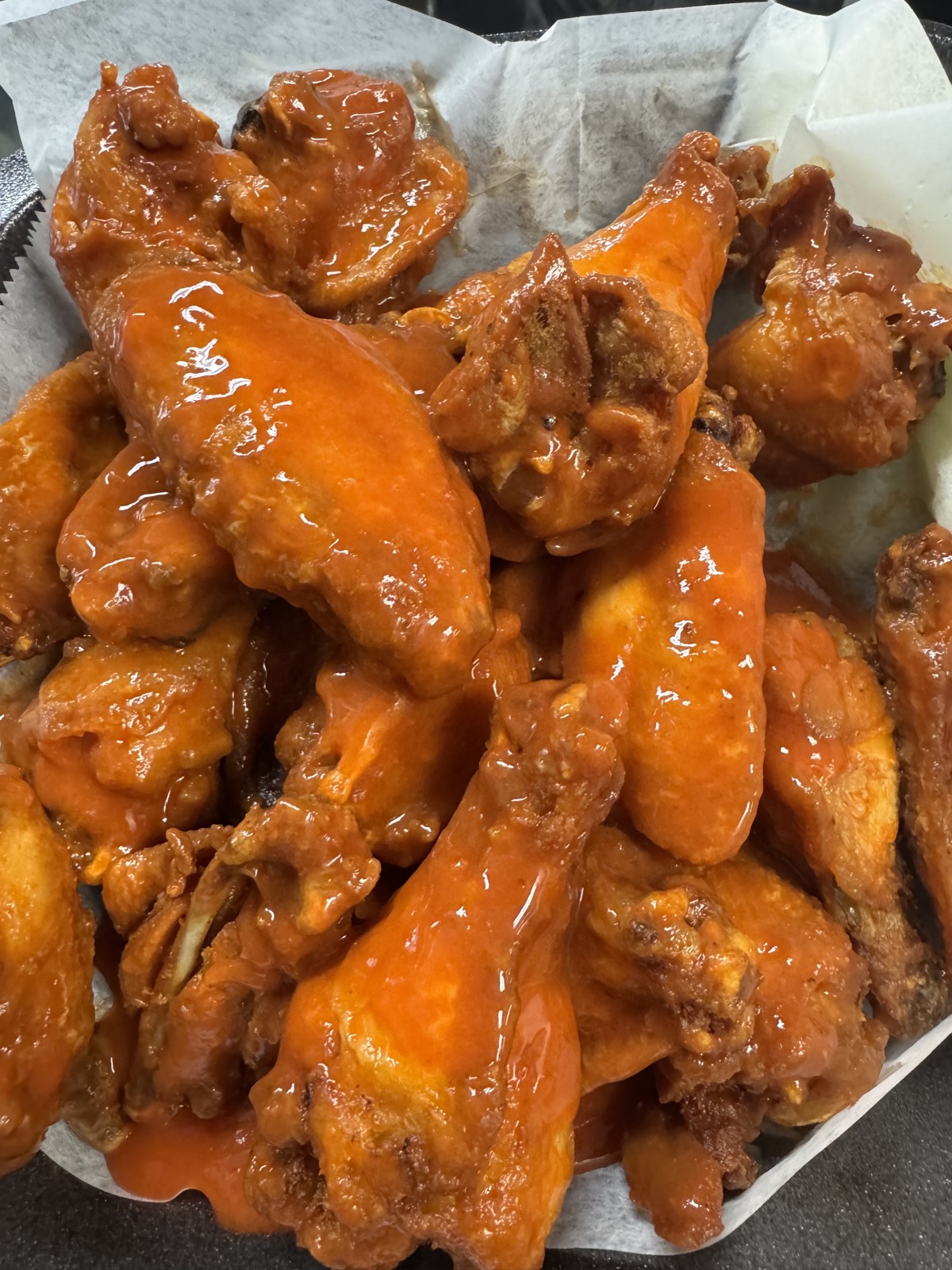 Buffalo wings piled in a tray